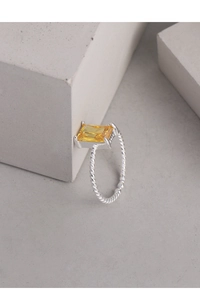 Detail of S925 silver ring featuring a rectangular yellow gemstone and twisted band design