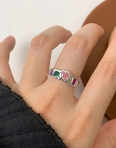 Macro detail of S925 silver ring featuring vibrant colorful zircons and heart-shaped gem