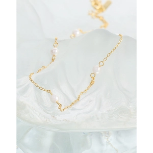 Minimalist S925 sterling silver gold necklace with white pearls on frosted glass