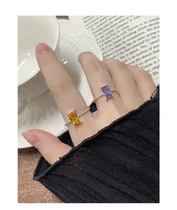 Detail of S925 silver rings with yellow and purple rectangle cut stones on rope band