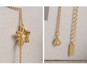 Detail showing S925 hallmark on gold snowflake bracelet with zircon star pendant