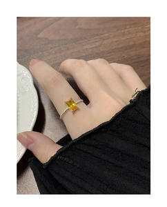 Macro shot of S925 silver ring featuring a rectangular yellow gemstone and twisted band