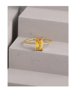 Macro shot of S925 silver twist ring featuring an emerald-cut yellow gemstone in four-prong setting