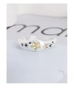 Macro shot of S925 sterling silver star ring with inlaid yellow and pink cubic zirconia