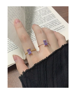 Close-up of S925 sterling silver ring featuring a purple rectangular zircon and twisted band