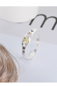 Macro shot of S925 silver ring featuring yellow star zircon and black star engravings