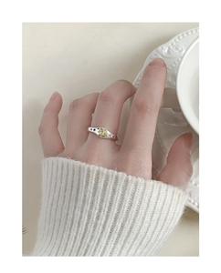 Detailed macro view of S925 silver wave ring with yellow zircon star inlay