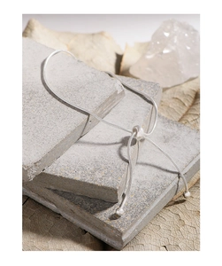 Close-up of adjustable silver snake chain bracelet with slide buckle on stone layers