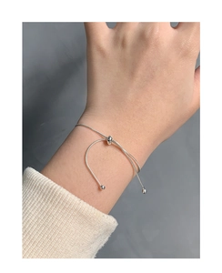 Close-up of adjustable S925 silver snake chain bracelet on wrist with slider bead