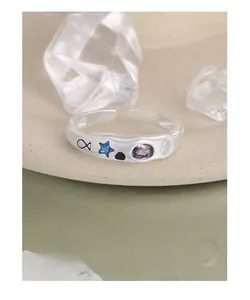 Detail of S925 silver adjustable ring with irregular texture and inlaid colorful stones