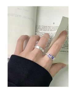 Dettaglio anello in argento S925 con texture irregolare e due zirconi viola incastonati
