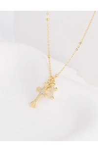 Detail of S925 silver gold-plated double cross necklace with shimmering zircon stones
