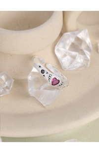 Macro detail of S925 silver ring featuring pink heart gem and black zircon stones