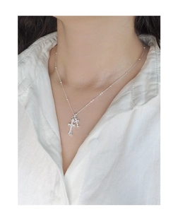 Close-up of S925 sterling silver layered cross necklace with sparkling zircon stones