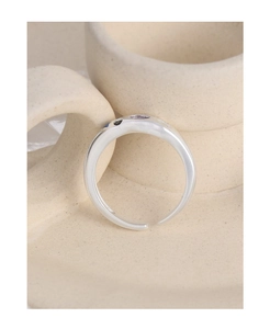 Artistic detail of S925 silver adjustable ring with dark zircon gemstone on ceramic cup