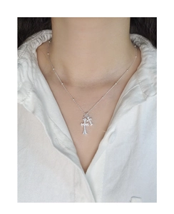 Detailed close-up of S925 silver double cross pendant necklace with vintage engraving