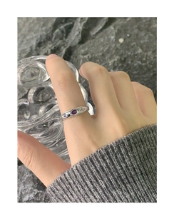 Detail of silver S925 ring featuring purple gemstone and star accents in bohemian style