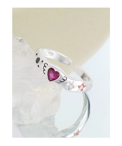 Macro detail of S925 silver ring featuring heart-shaped ruby zircon and star motifs
