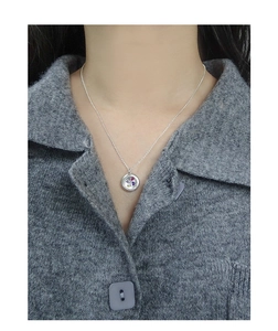 Close-up of S925 silver round pendant necklace featuring four colorful zircon gemstones