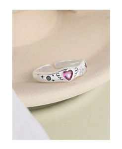 Detail of S925 silver ring featuring pink heart gemstone and carved wing accents