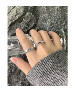 Detail of silver S925 rings with colorful cubic zirconia inlays on a hand