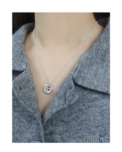 Detail of silver necklace with colorful heart gems pendant worn on model neck
