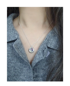 Close-up of S925 silver necklace with a round pendant featuring multi-color mini zircon stones
