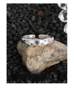 Macro detail of S925 silver ring with irregular texture and colorful zircon stones