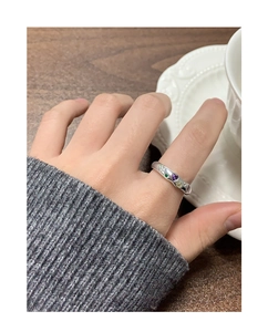 Close-up of S925 silver irregular ring with colorful heart-shaped zircons worn on finger