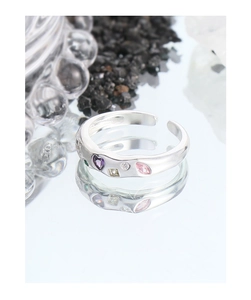 Detail of S925 silver open ring featuring colorful zircons and textured finish