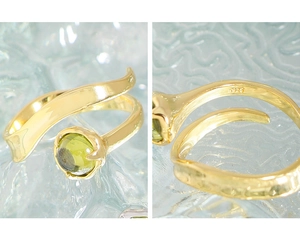 Macro shot of S925 sterling silver ring featuring a round green gemstone and smooth finish