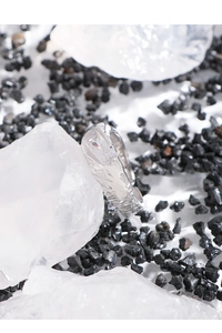 Detail of S925 silver ring with irregular lava texture and a rectangular zircon stone