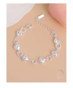 Detail of S925 sterling silver heart bracelet with twisted rings and extension chain