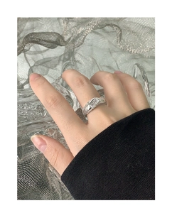 Macro detail of S925 silver ring with crushed texture and rectangular zircon inlay