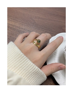 Close-up of a retro gold S925 silver ring featuring a round dark green gemstone inlay
