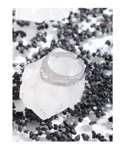 Macro shot of S925 sterling silver ring with lava texture and zircon on white crystal