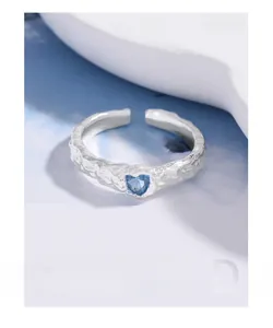 Detail of silver S925 heart ring featuring a unique lava texture and blue zircon stone