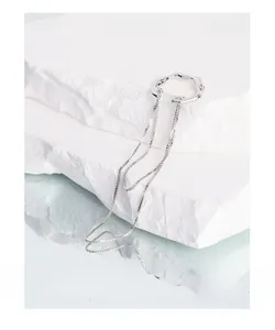 Macro shot of silver S925 tassel ear cuff with irregular wave design on stone