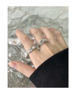 Detail of S925 silver rings with wrinkled texture, pearl and zircon on model's hand