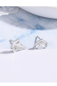 Close-up of S925 sterling silver asymmetric earrings with leaf and flying bird designs