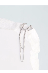 Close-up of S925 silver irregular tassel ear cuff on textured stone background