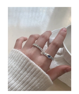 Detailed view of silver lava texture rings featuring a blue heart-shaped zircon stone