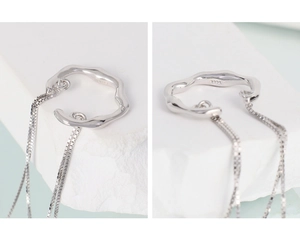 Macro shot of S925 sterling silver tassel ear clip showing wave design and box chains