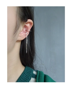 Detail of silver tassel ear cuff clip on a model featuring long chain fringe design