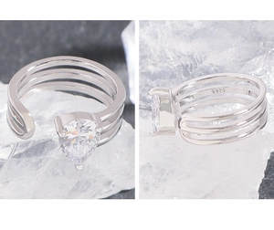 Macro detail showing S925 hallmark and pear-cut zircon on triple-layered silver ring
