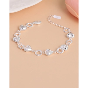 S925 sterling silver twist chain bracelet with heart pendants on beige background