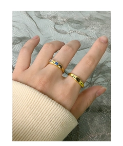 Close-up of gold s925 rings with colorful zircons worn on model for luxury style