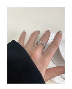 Close-up of minimalist S925 silver starburst ring with sparkling zircon snowflakes