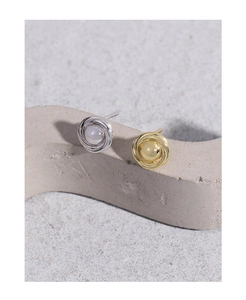 Detail view of S925 silver and gold spiral knot stud earrings with moonstone gem