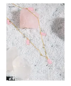 Close-up of S925 silver gold-plated necklace with elegant pink agate beads on a soft background